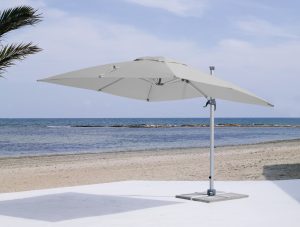 Commercial cantilever umbrella with silver canopy and frame.